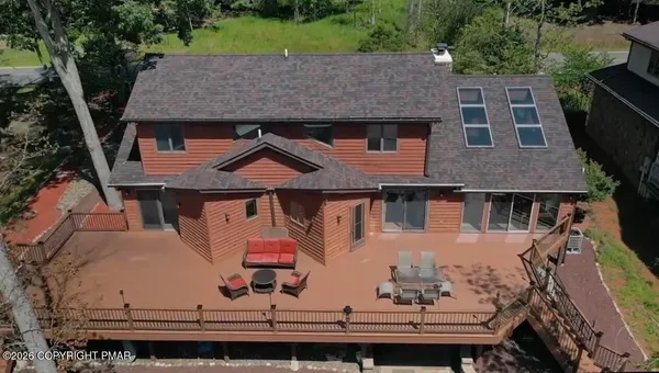 an aerial view of a house with a yard
