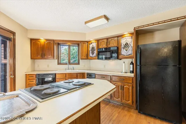 an aerial view of a houses with a yard and lake view