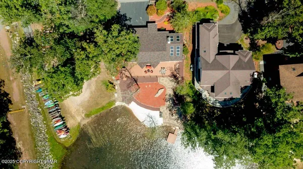an aerial view of a house with a yard and trees