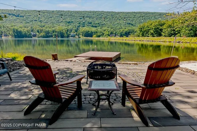a roof deck with a table and chairs