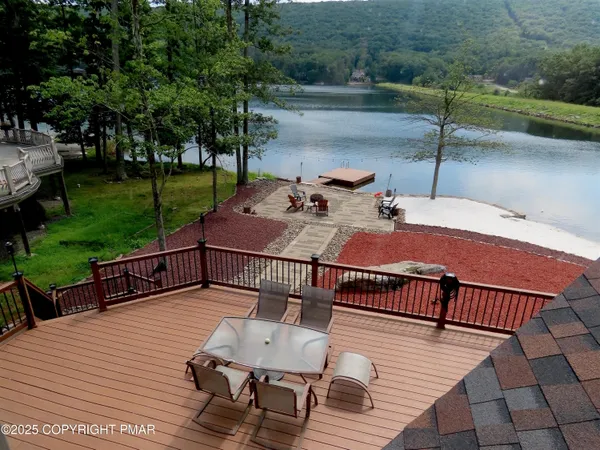 a view of balcony with wooden floor and outdoor seating