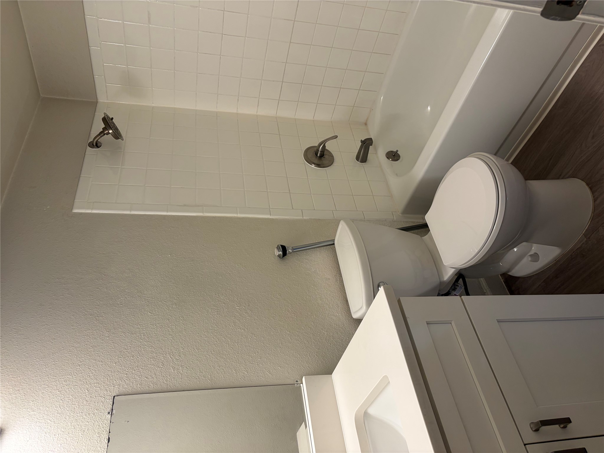 4501 Speedway, Unit 101 Austin, TX 78751 - Photo 5 of 7 A well-appointed bathroom features a modern vanity, toilet, and a tiled shower-tub combination.