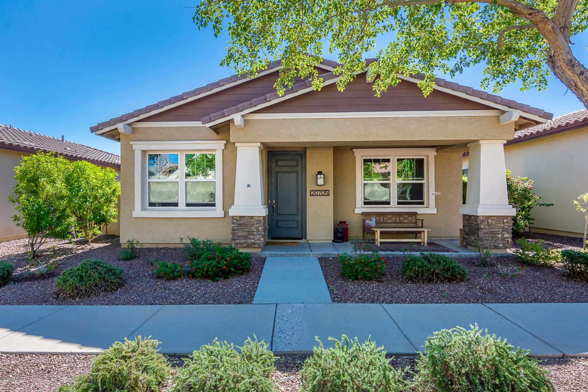 20705 West Ridge Road Buckeye, AZ 85396 - Photo 1 of 26 a front view of a house with garden