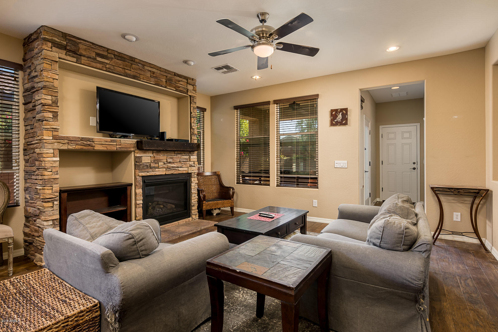 20705 West Ridge Road Buckeye, AZ 85396 - Photo 13 of 26 a living room with furniture a flat screen tv and a fireplace