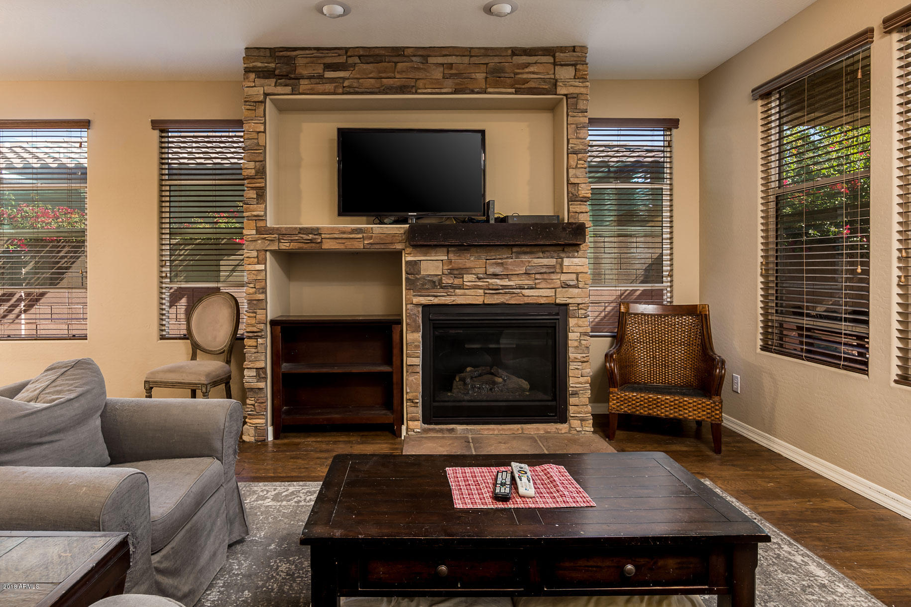 20705 West Ridge Road Buckeye, AZ 85396 - Photo 15 of 26 a living room with furniture a flat screen tv and a fireplace