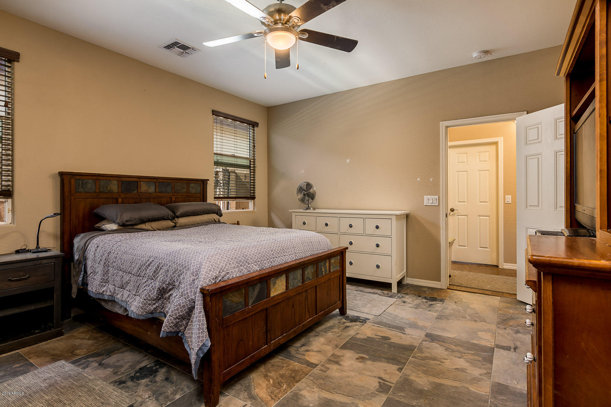 20705 West Ridge Road Buckeye, AZ 85396 - Photo 17 of 26 a bedroom with a bed and a chandelier