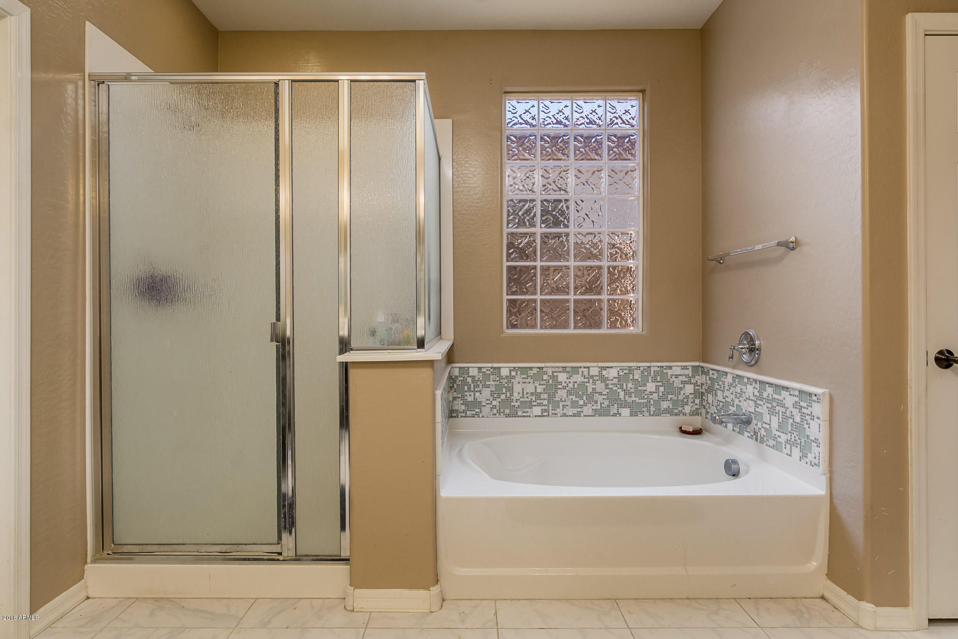20705 West Ridge Road Buckeye, AZ 85396 - Photo 19 of 26 a bathroom with a bathtub and a shower