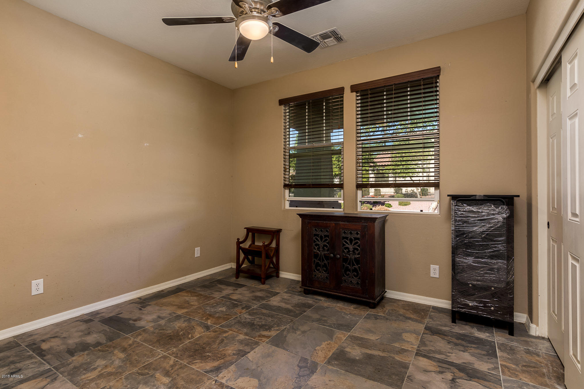 20705 West Ridge Road Buckeye, AZ 85396 - Photo 20 of 26 a view of an empty room with a fireplace and a window