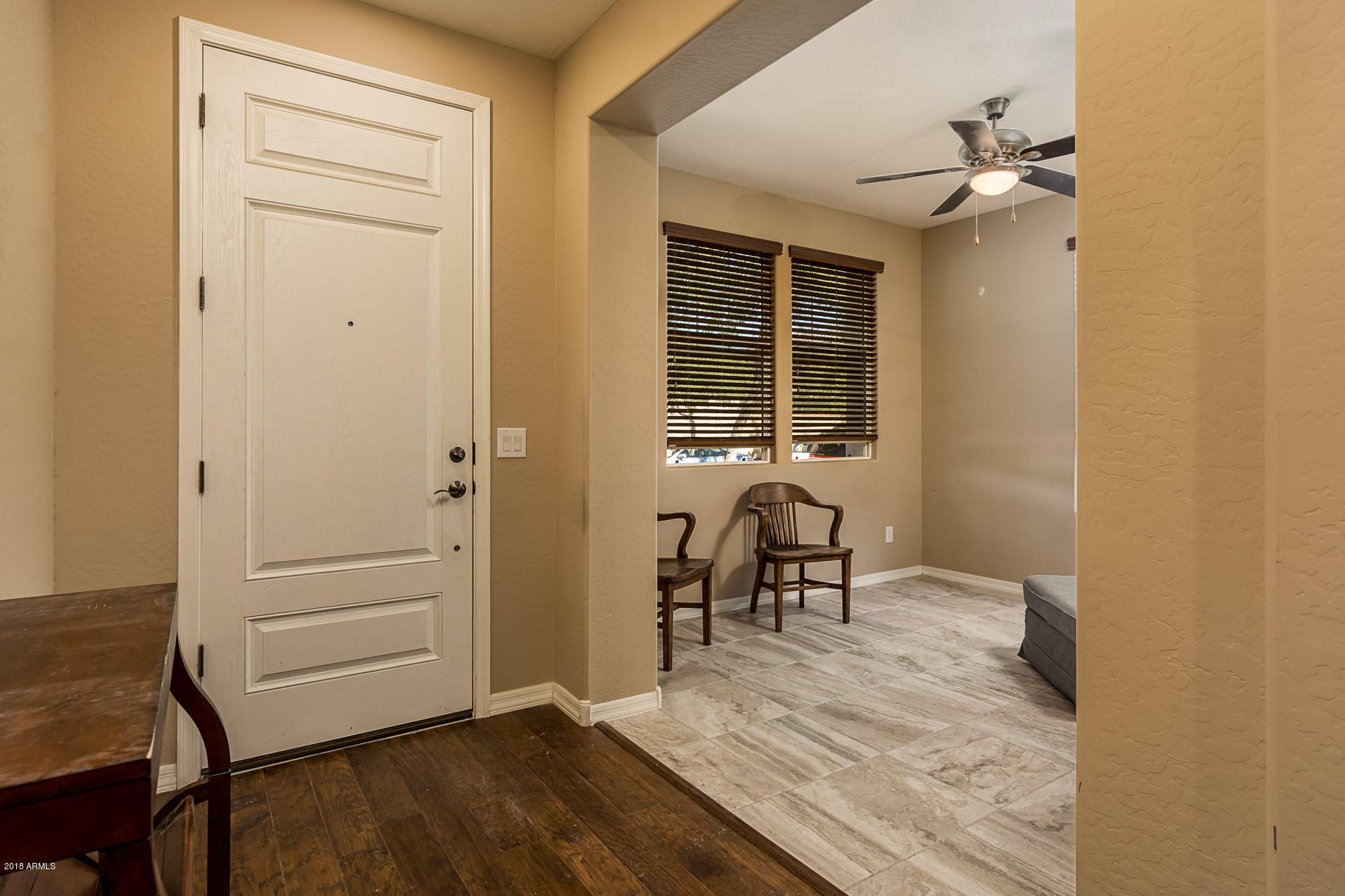 20705 West Ridge Road Buckeye, AZ 85396 - Photo 4 of 26 an empty room with wooden floor table and chairs