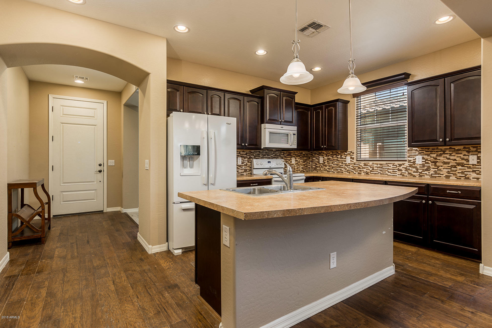 20705 West Ridge Road Buckeye, AZ 85396 - Photo 6 of 26 a kitchen with stainless steel appliances granite countertop a sink stove and refrigerator