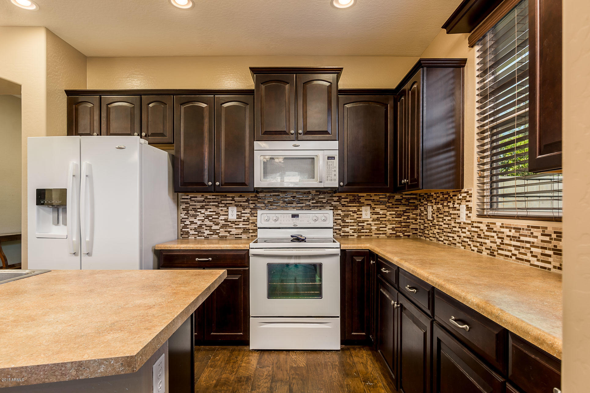 20705 West Ridge Road Buckeye, AZ 85396 - Photo 10 of 26 a kitchen with stainless steel appliances granite countertop a refrigerator and a stove top oven