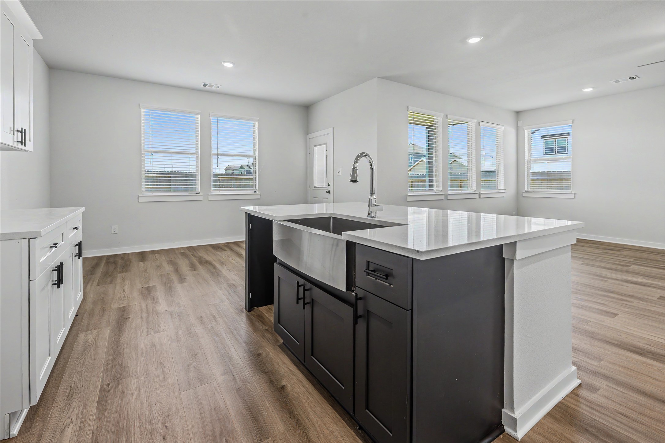 6427 Bolinas Court Rosharon, TX 77583 - Photo 16 of 49 a kitchen with stainless steel appliances granite countertop a sink stove and wooden floor