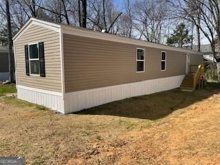 a view of a small house with a yard