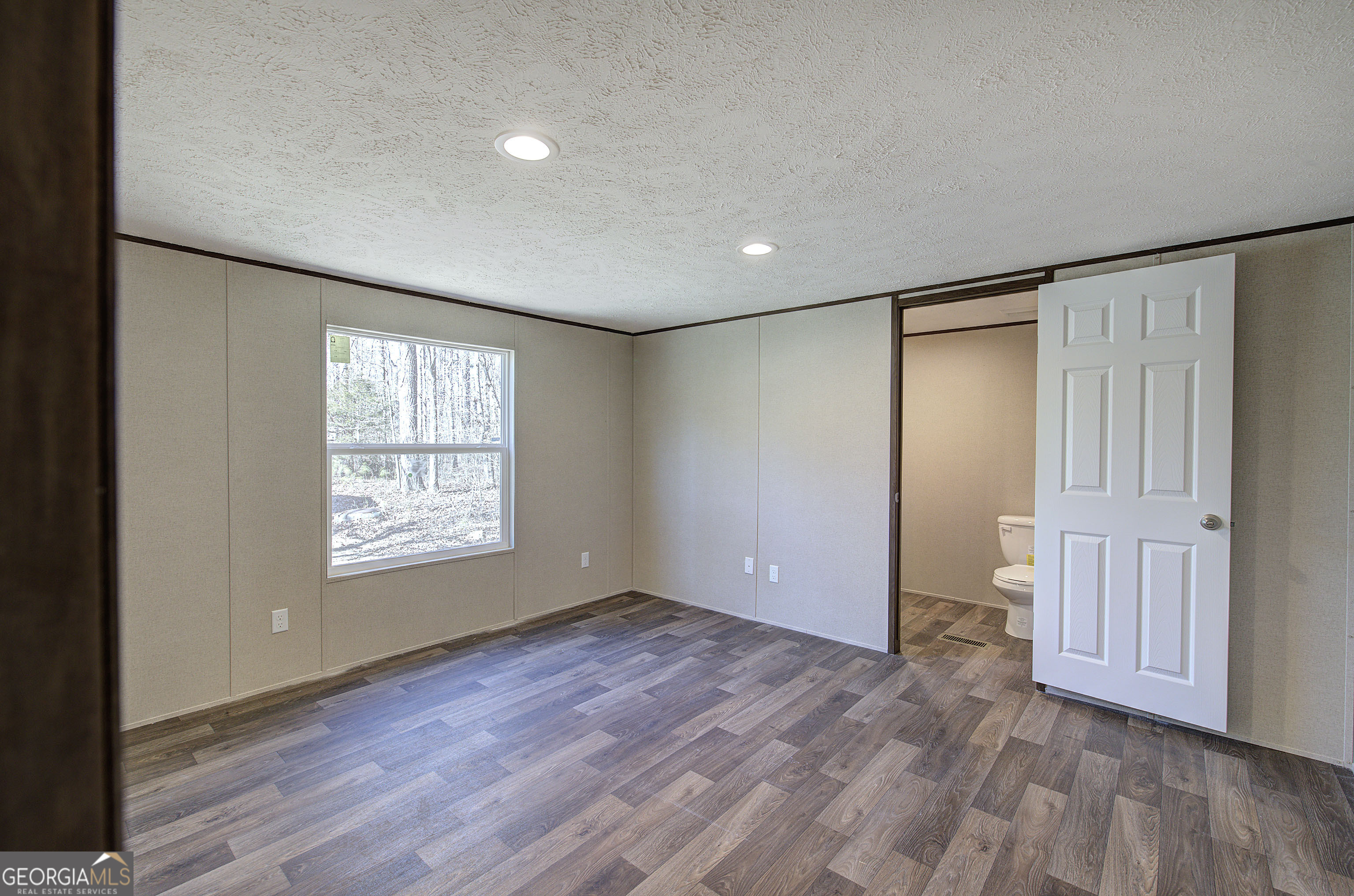 235 A West Big Indian Trail Rome, GA 30165 - Photo 21 of 28 an empty room with wooden floor and windows