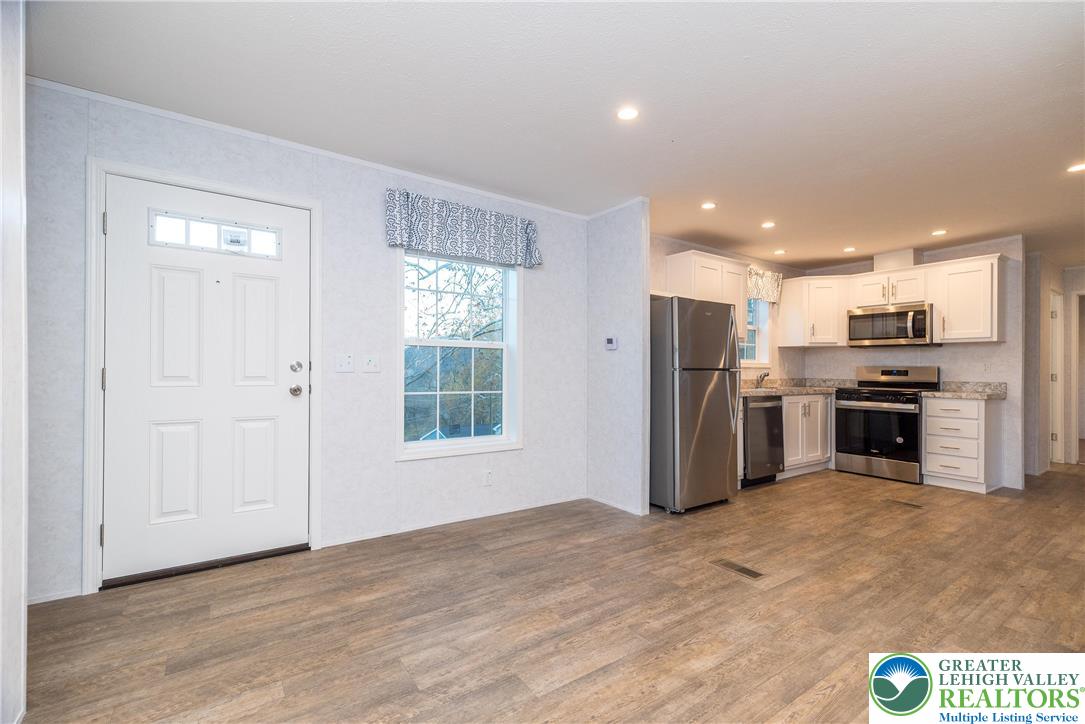 465 Royal Manor Road, Unit LOT 1 Easton, PA 18042 - Photo 4 of 15 a kitchen with stainless steel appliances a refrigerator and a stove top oven