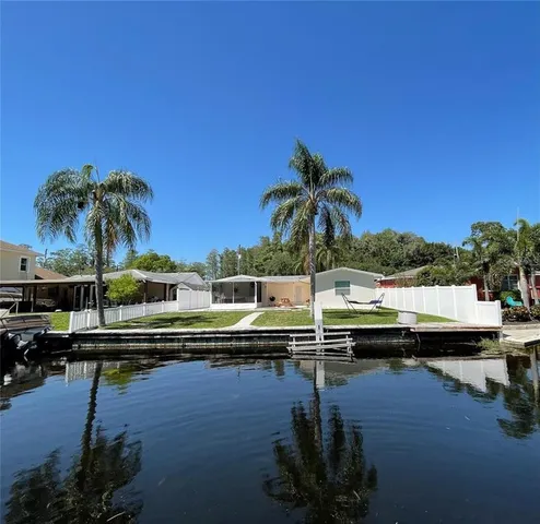 a view of swimming pool with outdoor seating and lake view