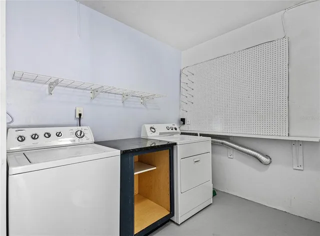 a view of a house with a yard and palm trees