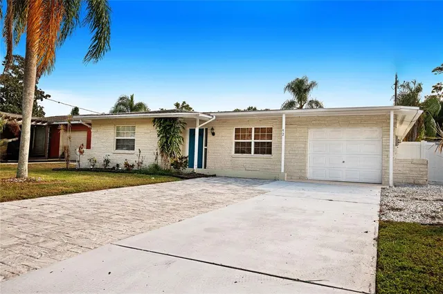 a view of a house with a backyard