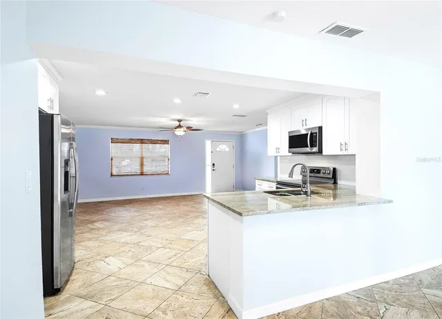 a kitchen with kitchen island sink refrigerator and microwave