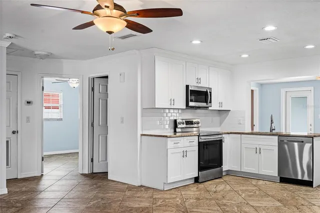 a view of a kitchen with a sink and microwave