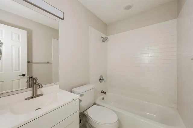 a bathroom with a sink toilet vanity and shower