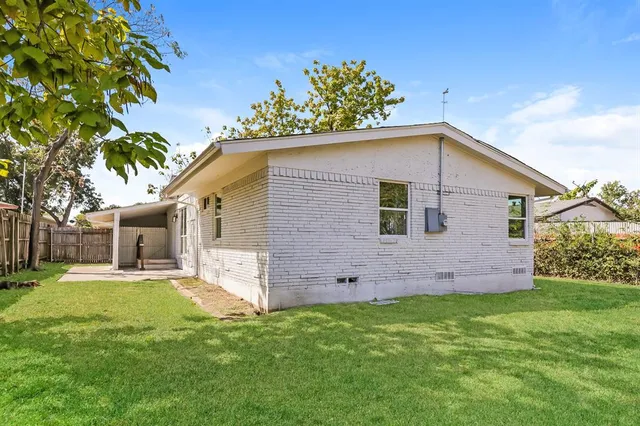 a front view of house with a garden