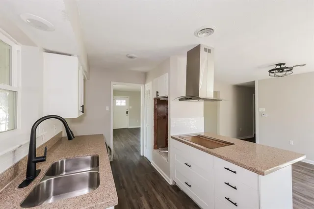 a kitchen with a refrigerator and a sink
