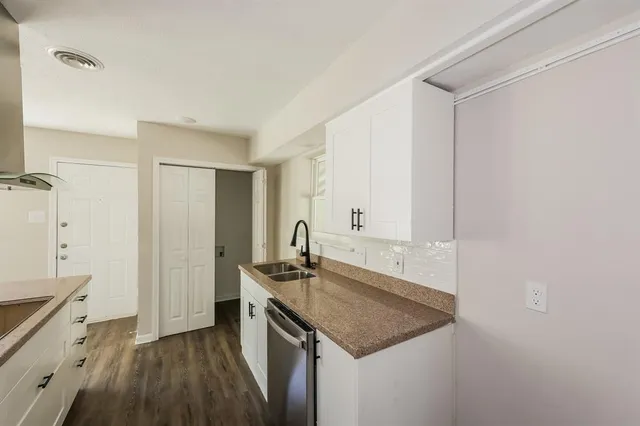 a kitchen with a sink stove and cabinets