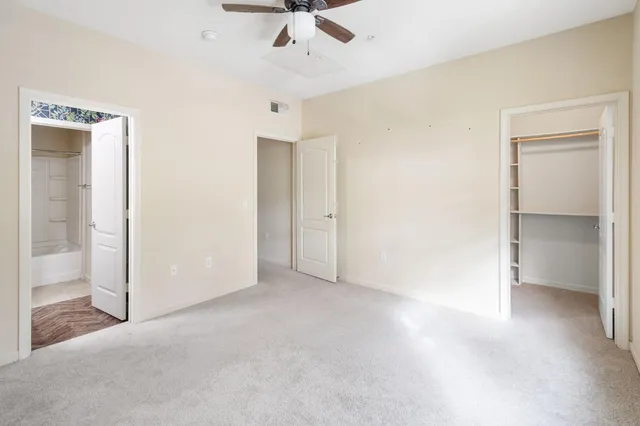 an empty room with a empty space and a ceiling fan