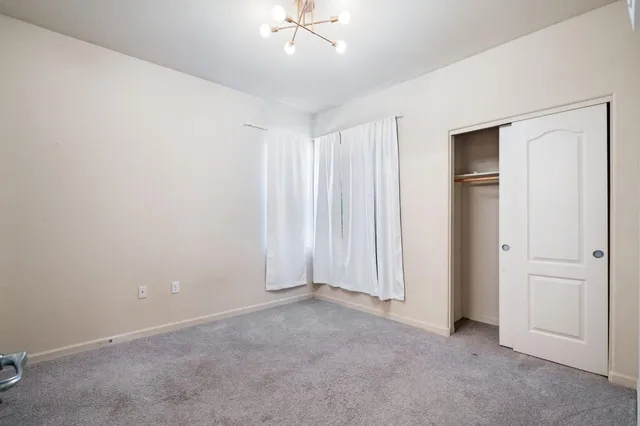 an empty room with closet area