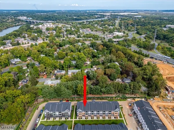 an aerial view of residential houses with outdoor space and swimming pool