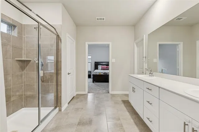 a bathroom with a double vanity sink and a mirror
