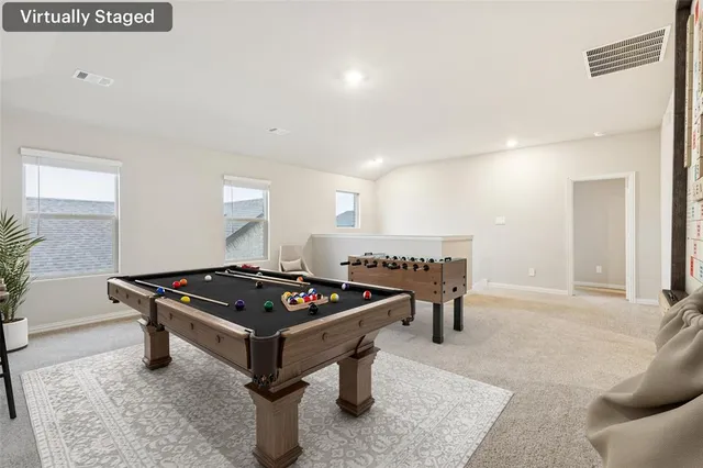 a living room with furniture a table and a flat screen tv