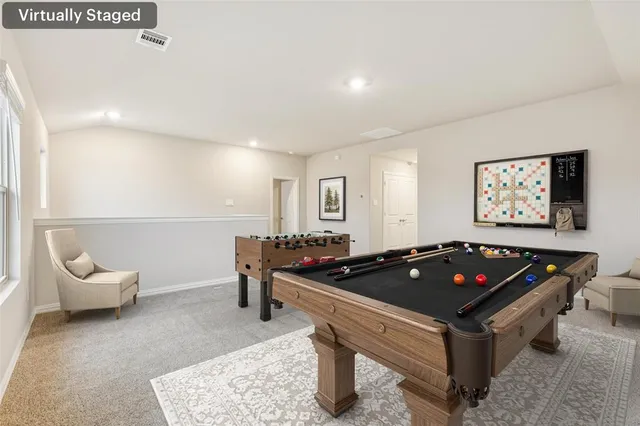 a living room with furniture pool table and furniture