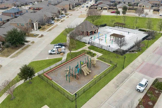 an aerial view of a residential houses with outdoor space