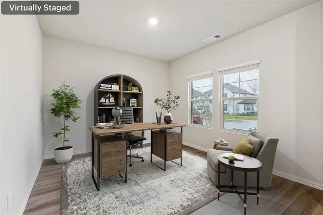 a view of a workspace with furniture and a window