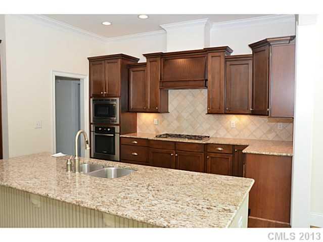 1008 Perriwinkle Lane Fort Mill, SC 29708 - Photo 2 of 16 a kitchen with granite countertop a refrigerator and a stove top oven
