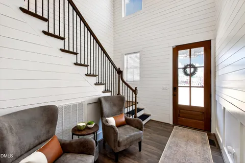 a living room with furniture and stairs