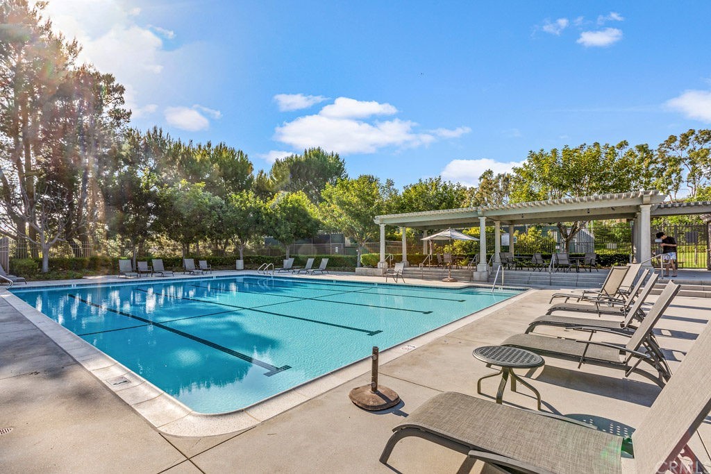 8 Highland View, Unit 3 Irvine, CA 92603 - Photo 23 of 24 a view of swimming pool with seating area and trees in the background