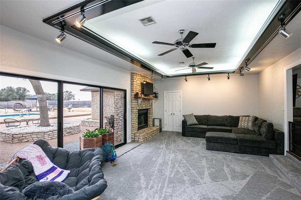 735 Willow Grove Road Woodway, TX 76712 - Photo 12 of 39 a living room with furniture ceiling fan and a large window