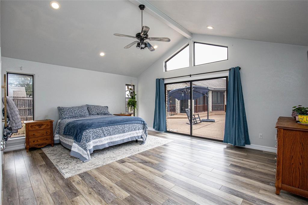 735 Willow Grove Road Woodway, TX 76712 - Photo 13 of 39 a spacious bedroom with a balcony a bed and a chandelier