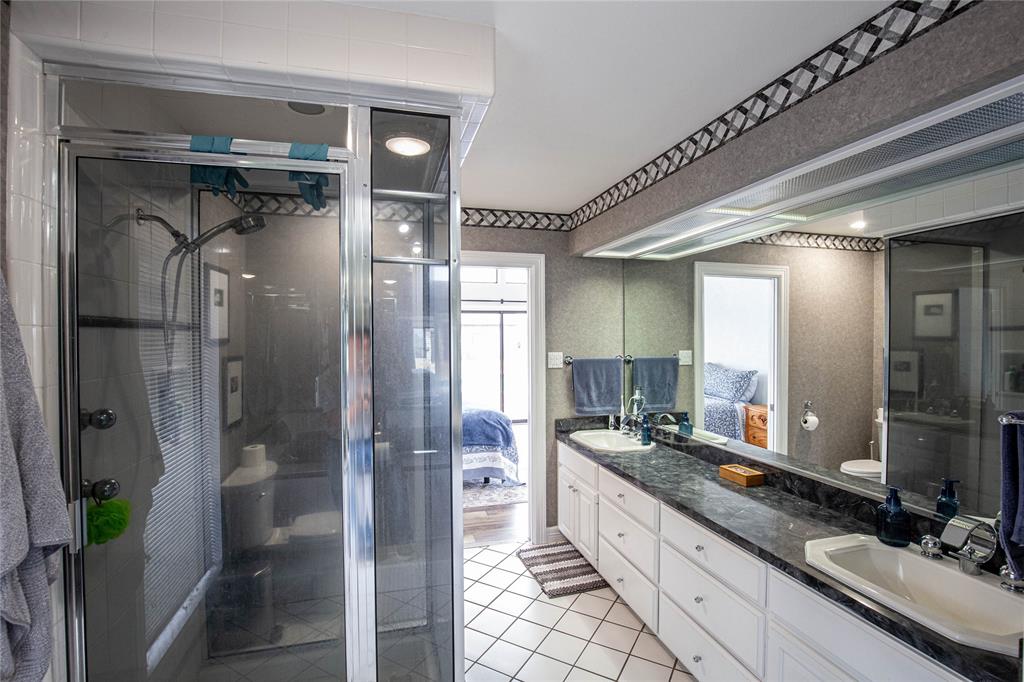 735 Willow Grove Road Woodway, TX 76712 - Photo 16 of 39 a large bathroom with a double vanity sink and a large mirror