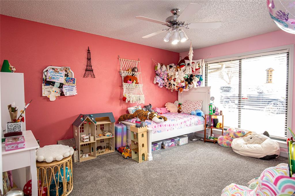 735 Willow Grove Road Woodway, TX 76712 - Photo 19 of 39 a bedroom with furniture and a chandelier