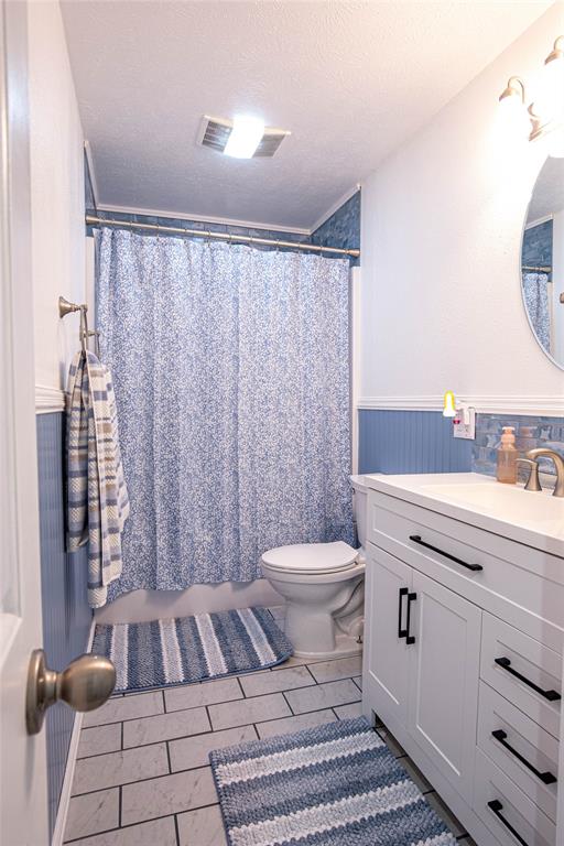 735 Willow Grove Road Woodway, TX 76712 - Photo 20 of 39 a bathroom with a toilet a sink and a mirror