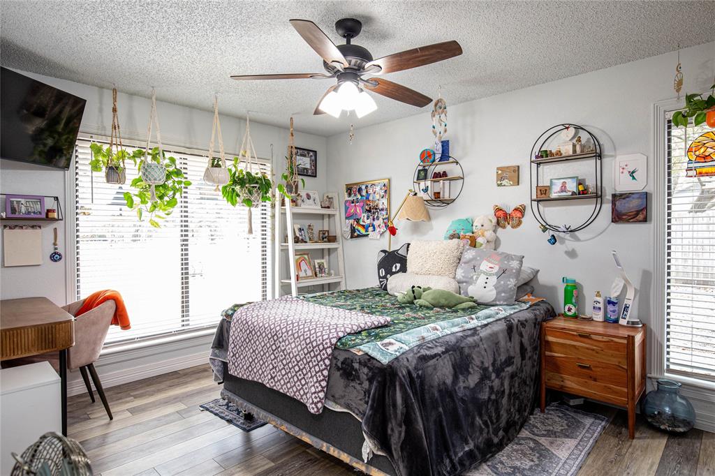 735 Willow Grove Road Woodway, TX 76712 - Photo 21 of 39 a bedroom that has a bed and a chandelier