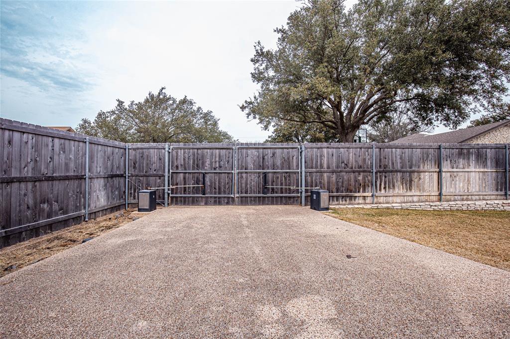 735 Willow Grove Road Woodway, TX 76712 - Photo 36 of 39 a view of a backyard with wooden fence