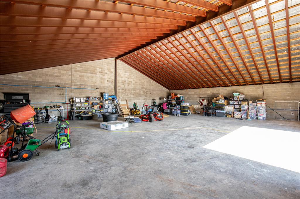 735 Willow Grove Road Woodway, TX 76712 - Photo 38 of 39 a view of a garage with a bike and white roof