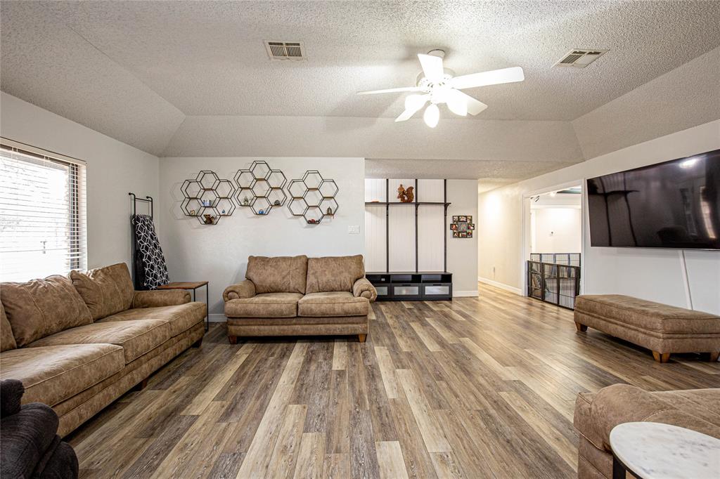 735 Willow Grove Road Woodway, TX 76712 - Photo 4 of 39 a living room with furniture and a flat screen tv