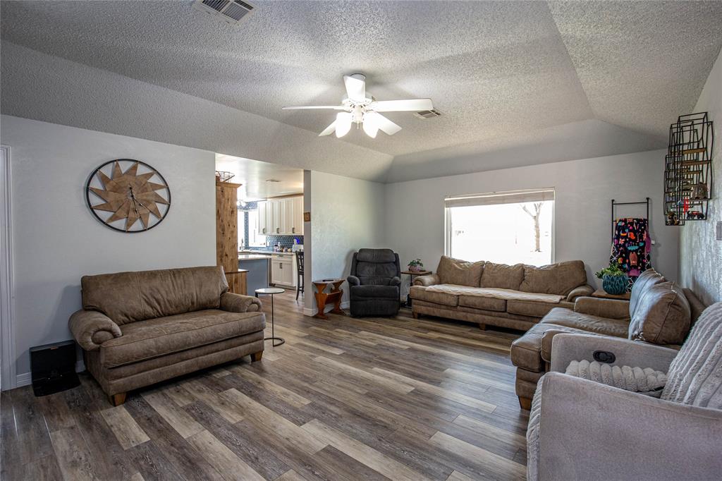 735 Willow Grove Road Woodway, TX 76712 - Photo 5 of 39 a living room with furniture a clock and a window