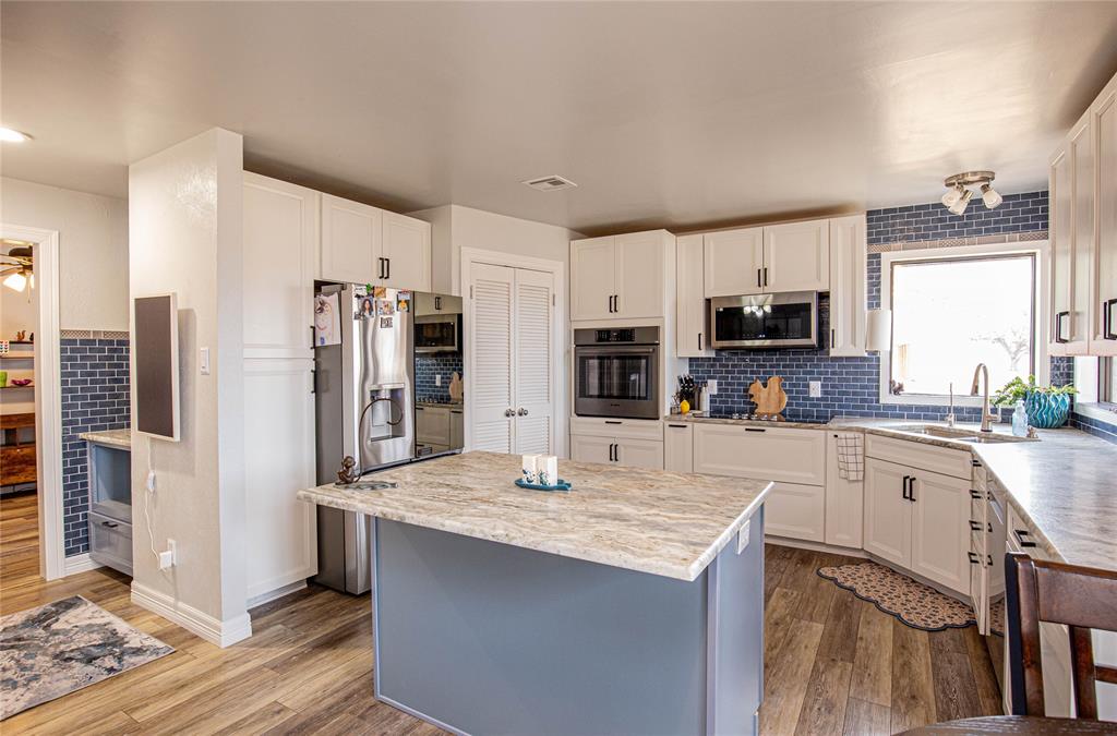 735 Willow Grove Road Woodway, TX 76712 - Photo 8 of 39 a kitchen with stainless steel appliances a stove refrigerator sink and microwave